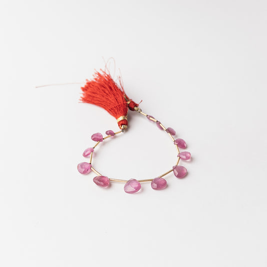 Ruby faceted briolette gemstone beads showcasing rich crimson red tones with exceptional sparkle and premium gemstone quality.