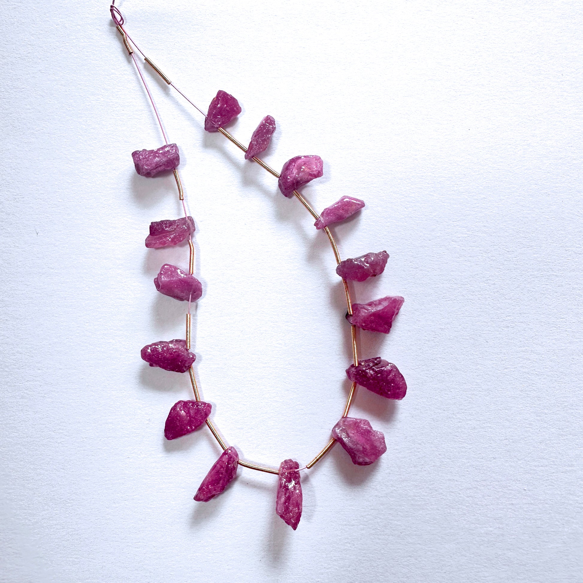 Rough side drilled ruby beads in 6-7mm size display vivid red tones and natural texture across 15 pieces.