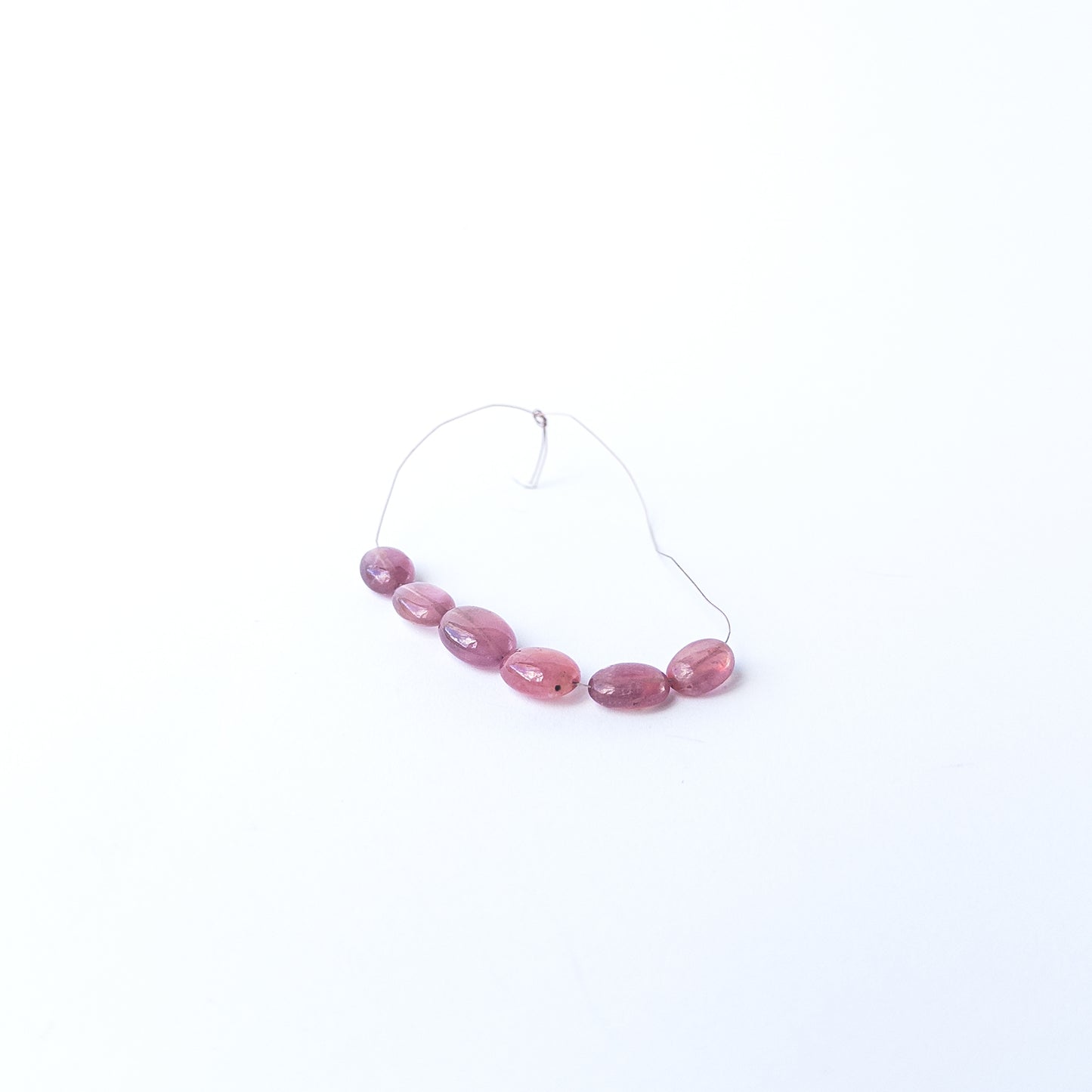 Ruby smooth oval gemstone beads with rich red colour arranged in a 7–8.9mm set for jewellery making.