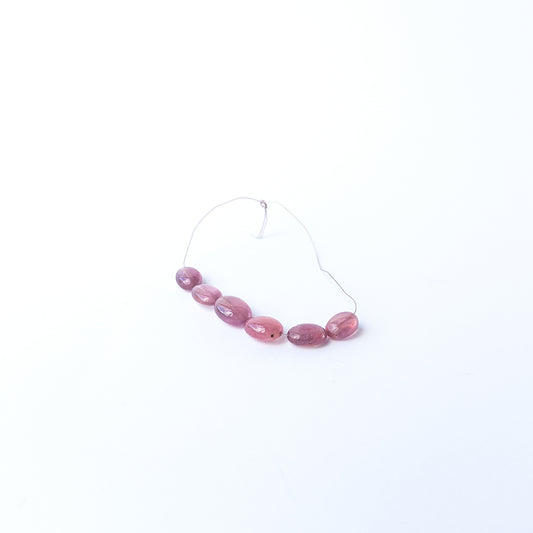 Ruby smooth oval gemstone beads with rich red colour arranged in a 7–8.9mm set for jewellery making.