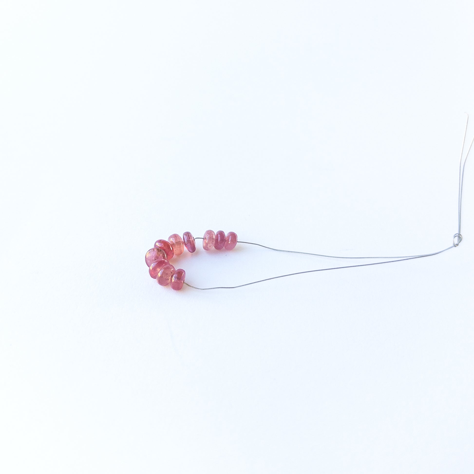 Authentic Ruby rondelle beads showcasing polished shine and vibrant crimson tones.