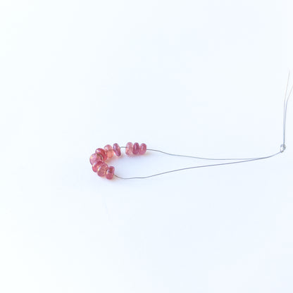 Authentic Ruby rondelle beads showcasing polished shine and vibrant crimson tones.
