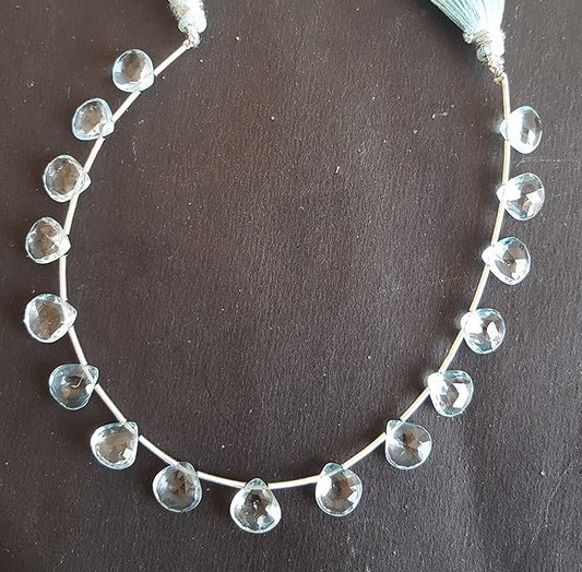 A beautiful strand  of colourful sky blue topaz gemstone beads, each shaped like faceted hearts.