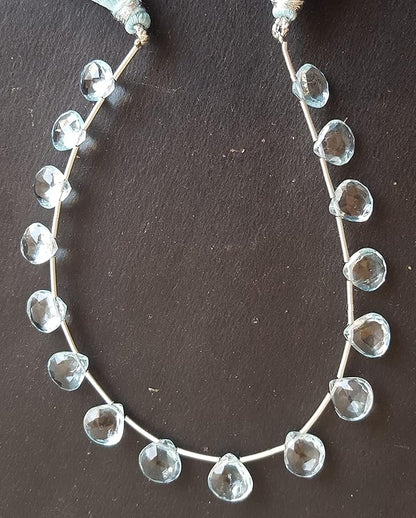 A strand made of heart shaped sky blue topaz gemstone beads in light blue hues.