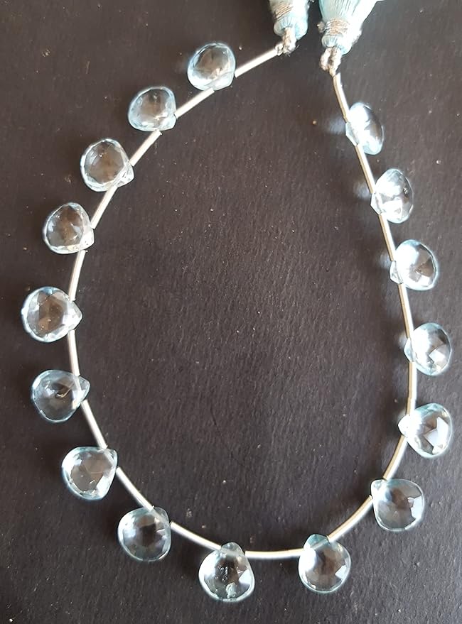 A stunning strand adorned with sky blue topaz gemstone beads, showcasing faceted heart shaped bead designs.