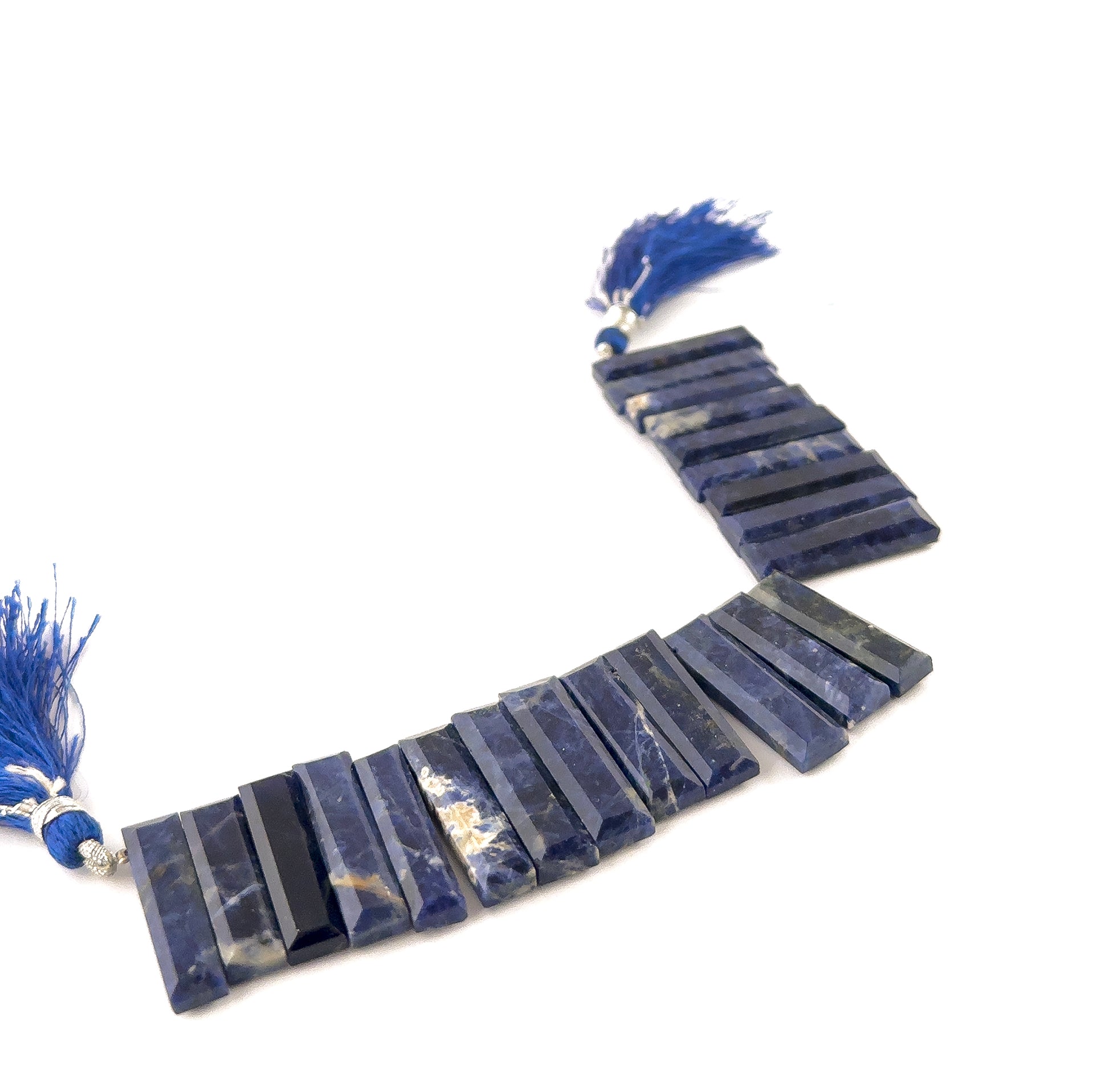 Sodalite faceted rectangle beads sized 6.5–7.5mm arranged in a 15cm strand, showing deep royal‑blue colour with natural gold flecks across 22 pieces.