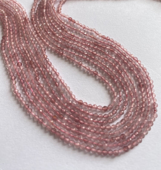 Close-up of Strawberry Quartz faceted rondelle beads, highlighting their refined cut and soft blush tones.