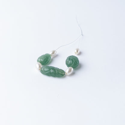 Handmade jewellery components featuring Green Strawberry Quartz and Shell Pearl carved tumble beads.