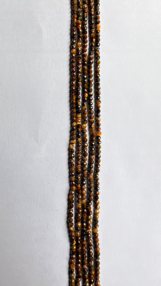 Tiger Eye micro-faceted rondelle beads in 2.2mm–2.5mm glow with warm chatoyance along a 32cm strand.