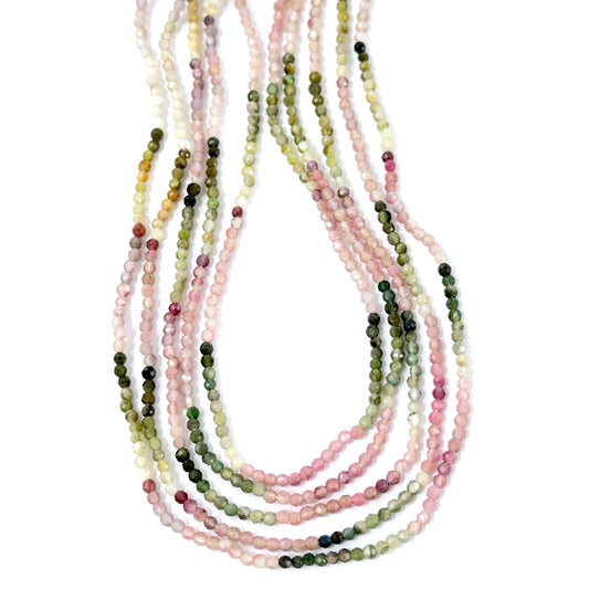 Close‑up of Tourmaline stone beads arranged in a strand with polished faceted surfaces.