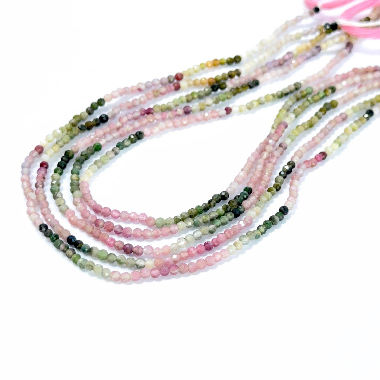 Tourmaline 2.2–2.3mm rondelle beads displaying vibrant tones and handmade jewellery components.