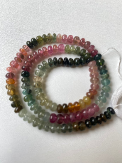 Multi-coloured strand made of 5mm smooth rondelle tourmaline beads, displaying a stunning array of colours and textures.
