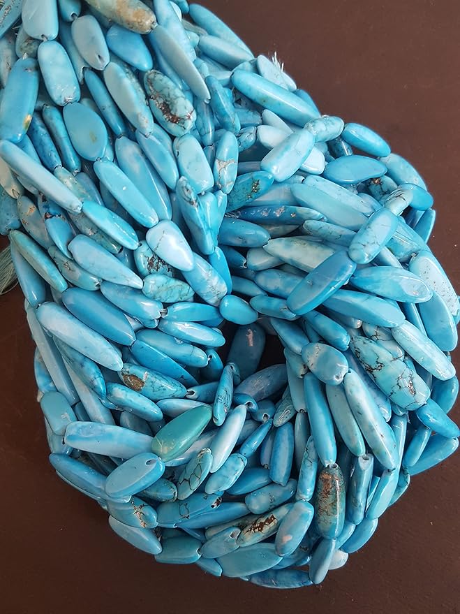 A cluster of smooth turquoise beads, sized between 6mm and 8mm, showcasing their rich colour and texture.