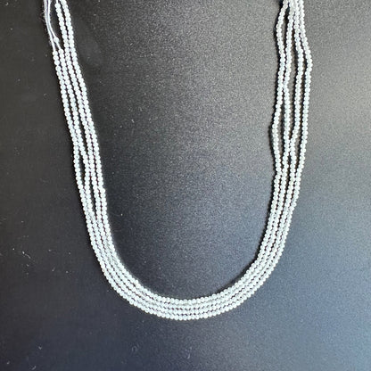 White Rainbow Moonstone rondelle beads sparkle under gentle lighting, enhancing their opalescent glow.
