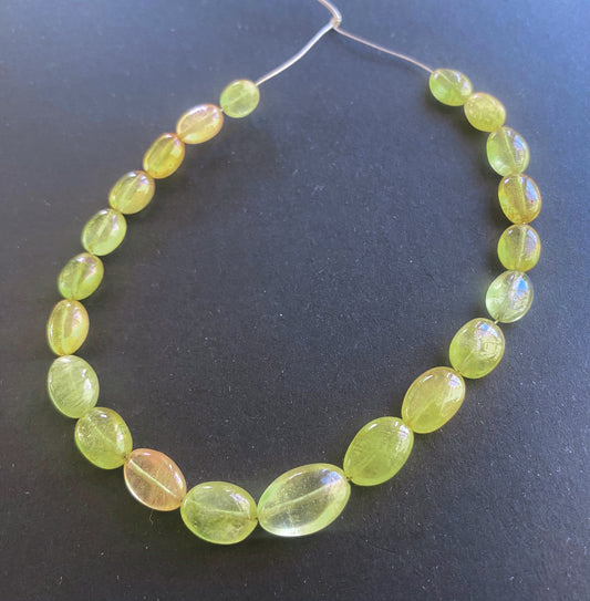 Yellow Sapphire oval beads with smooth finish and radiant golden tones arranged in a premium 21-piece set.