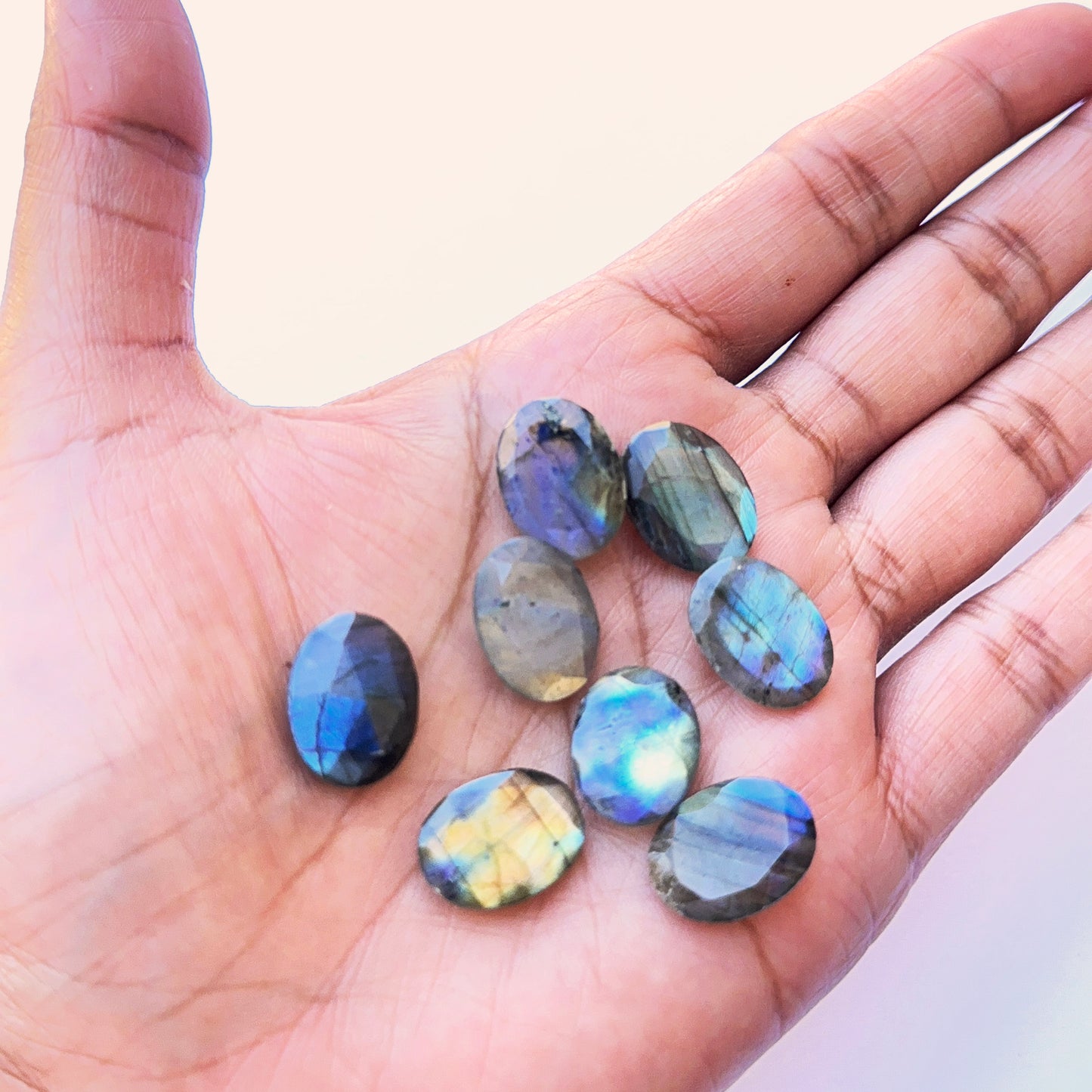 Detailed view of Labradorite cabochon showing polished surface, natural inclusions and vibrant colour play.