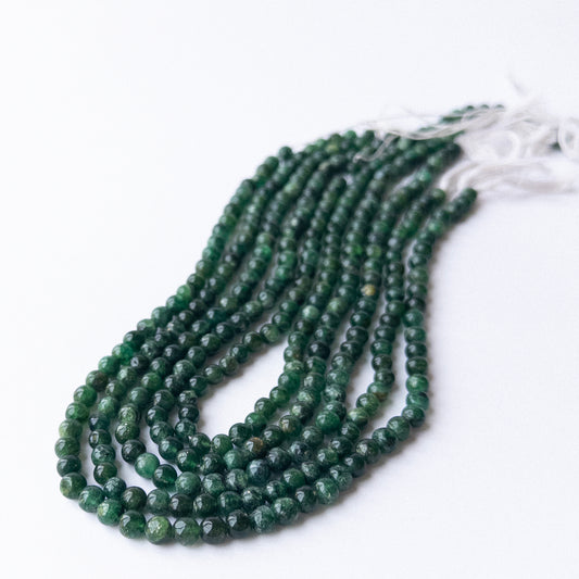 Close‑up of Aventurine smooth round beads highlighting natural colour, polish, and quality for DIY jewellery making.