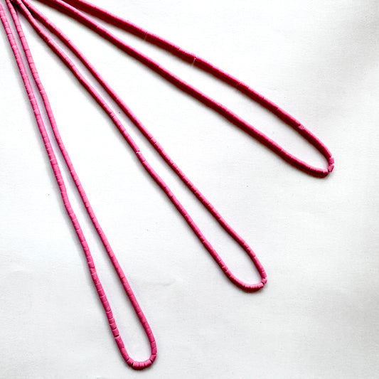 Finely shaped Afghan Pink Tube Heishi beads aligned to display cut precision and colour harmony.
