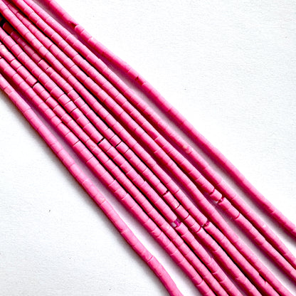 Close up of Pink afghan beads on a white background