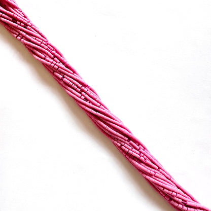 Afghan Pink Heishi beads in tube shape shown in soft blush colour across a 31cm strand.