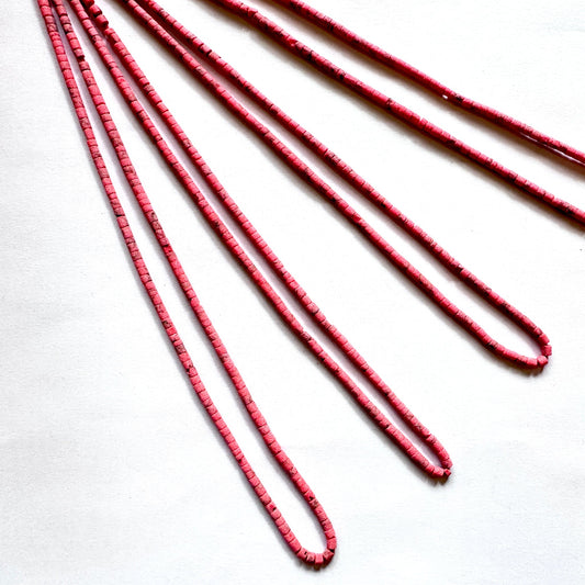 Tube shaped Heishi beads in Afghan style with earthy colours and 2.3–2.4mm sizing on 31cm strand.