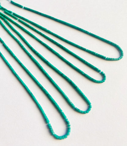 Tube-shaped Afghan Heishi beads in 2mm size arranged neatly on a 32cm strand with natural matte finish.