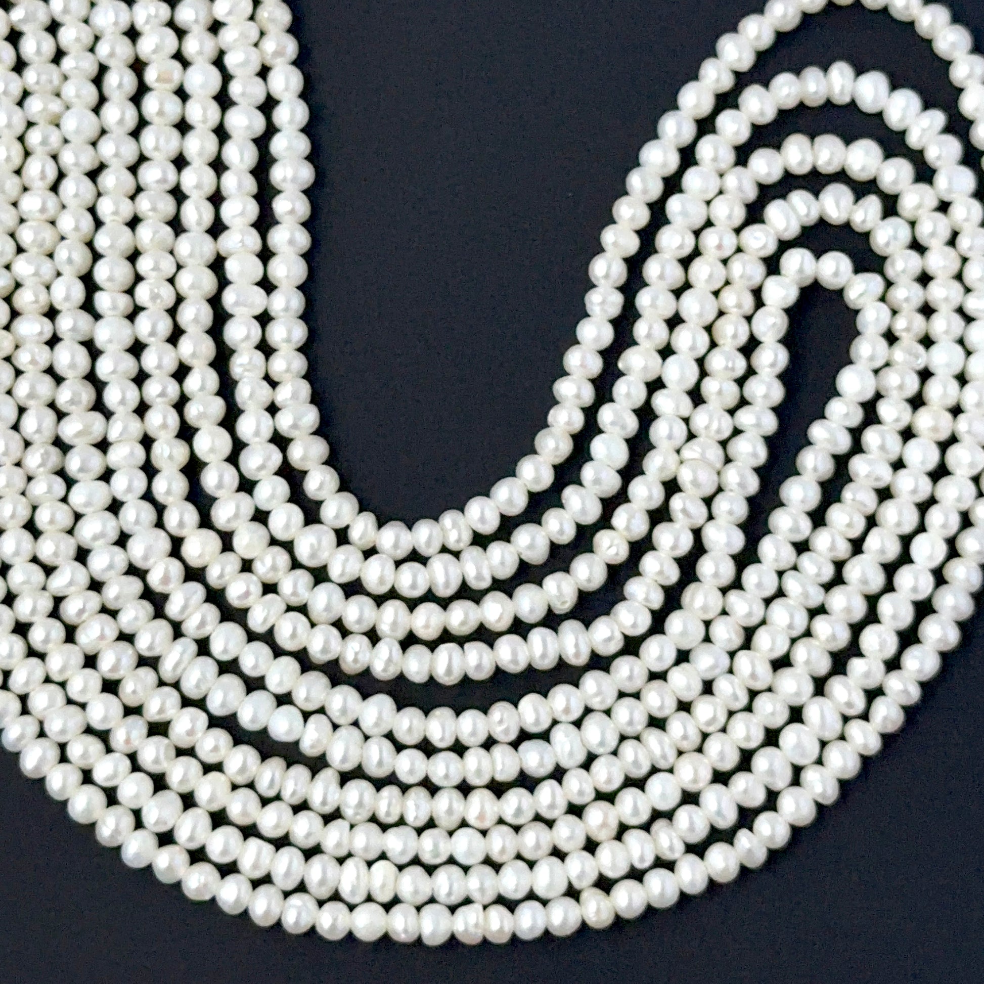 Dainty rondelle freshwater pearls in 2.5–3mm or 3–3.5mm sizes arranged neatly on a 39cm strand.