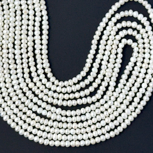 Dainty rondelle freshwater pearls in 2.5–3mm or 3–3.5mm sizes arranged neatly on a 39cm strand.