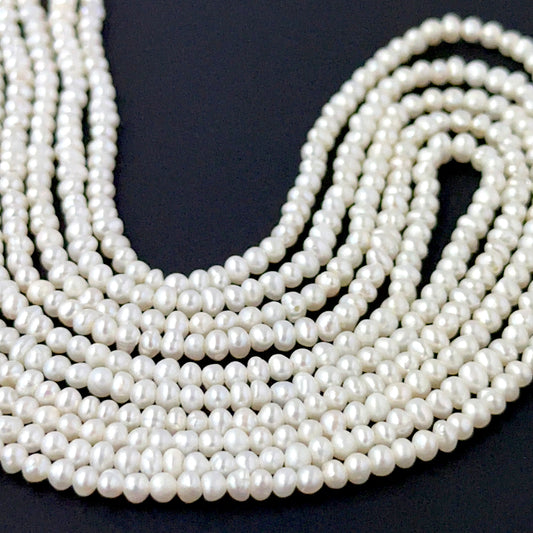 Freshwater pearl rondelles showing soft lustre and smooth handmade jewellery component quality.