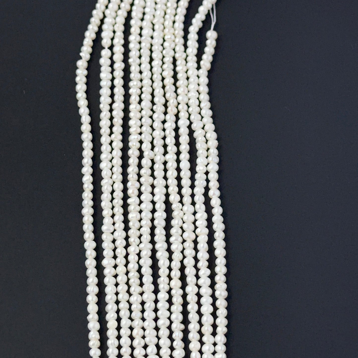 Close‑up of freshwater pearl rondelles showing detailed surface texture and soft pearl sheen.