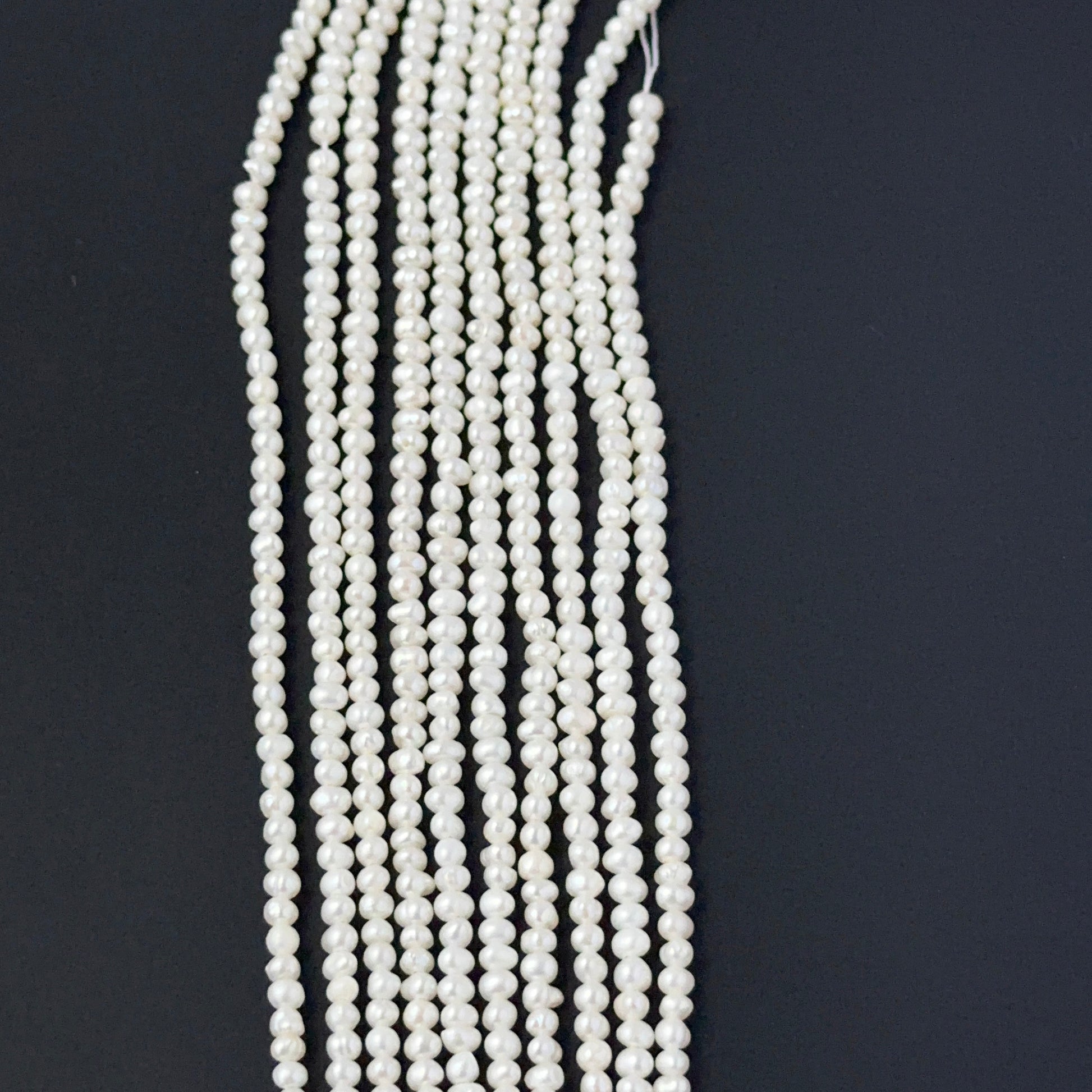 Close‑up of freshwater pearl rondelles showing detailed surface texture and soft pearl sheen.