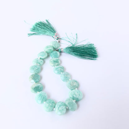 Amazonite faceted briolette gemstone beads in soft aqua tones arranged on a strand for handmade jewellery components.