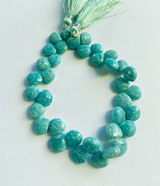 A strand of faceted Amazonite briolette heart beads in calming blue-green hues and high-quality gemstone finish. 