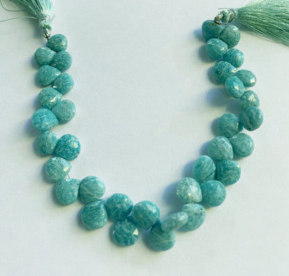 Close-up view of 9.5–10mm Amazonite heart beads, showing lustrous shine and precision-cut facets. 