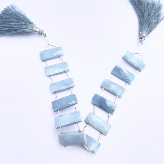 Close-up of Owyhee Opal gemstone beads showing faceted cut and polished surface.