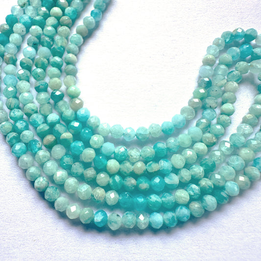 Amazonite gemstones arranged in a neat strand, showcasing their 2.7mm size and shimmering finish.
