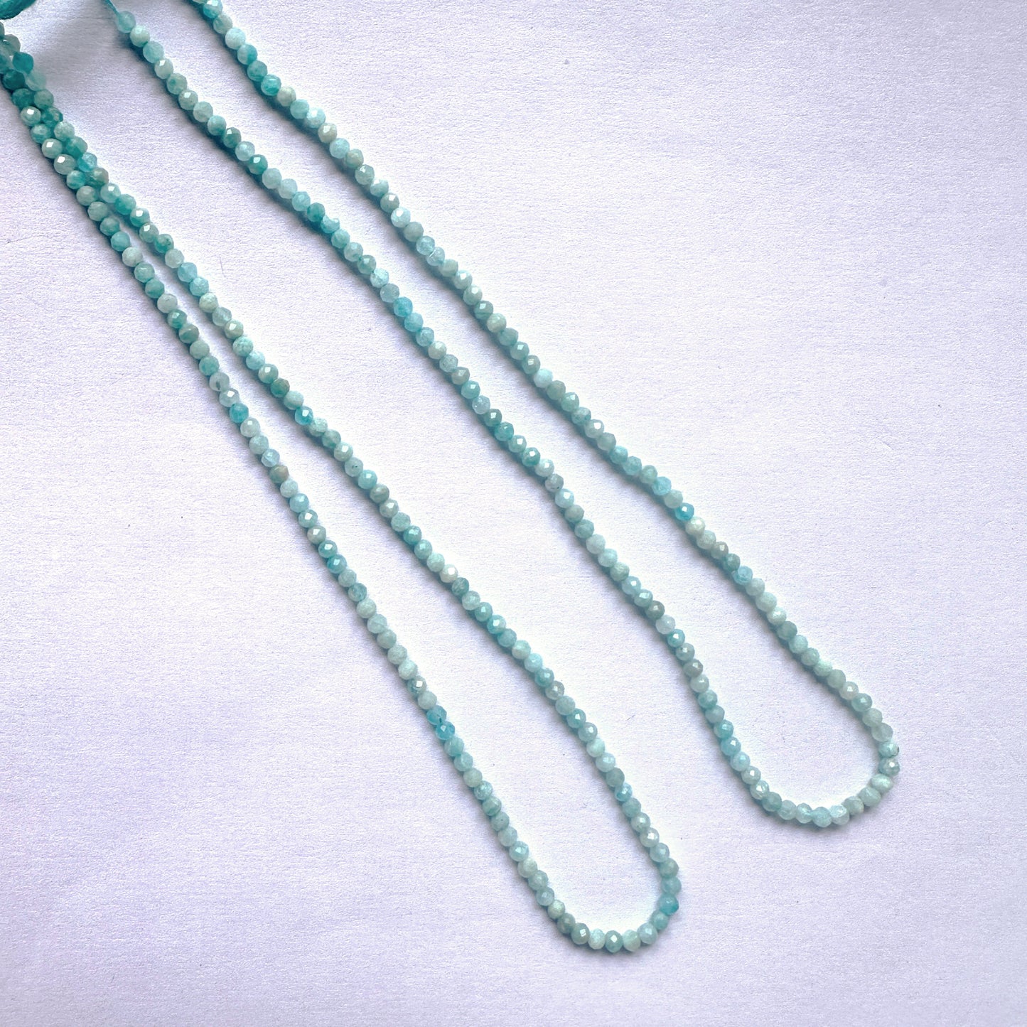 Faceted Amazonite rondelle beads with a calming aqua hue and consistent shape for elegant designs.