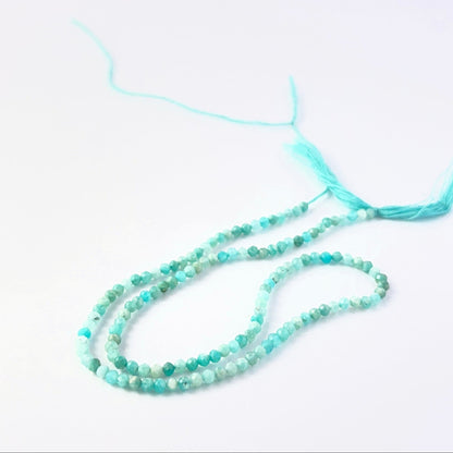 Faceted rondelle Amazonite beads arranged neatly, highlighting their polished finish and handmade jewellery component quality.