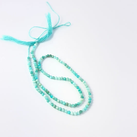 Amazonite rondelle beads with natural blue‑green hues and reflective faceting for creative jewellery designs.