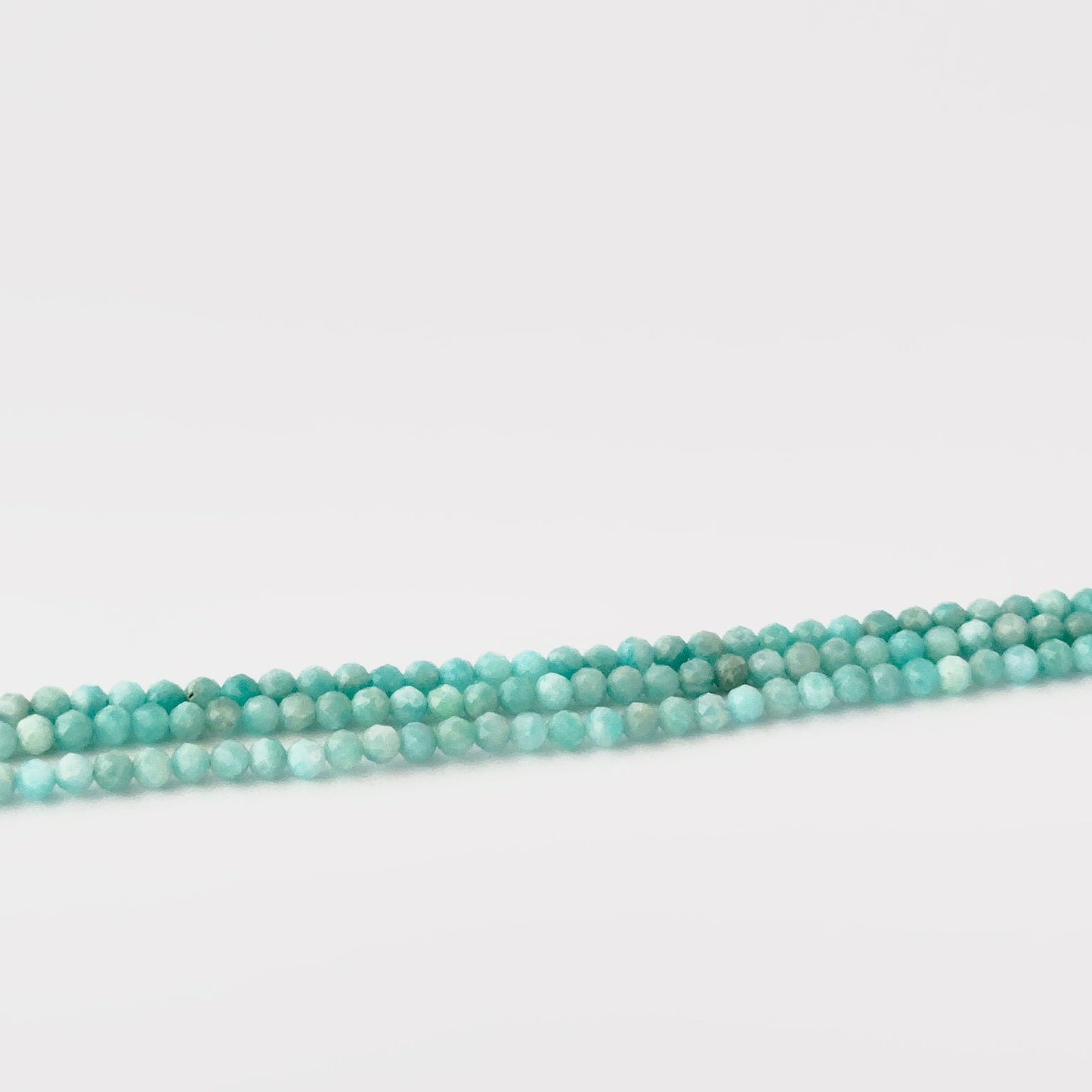 faceted rondelle beads Amazonite gemstone beads 3.4–3.5mm, arranged on a 31cm strand.