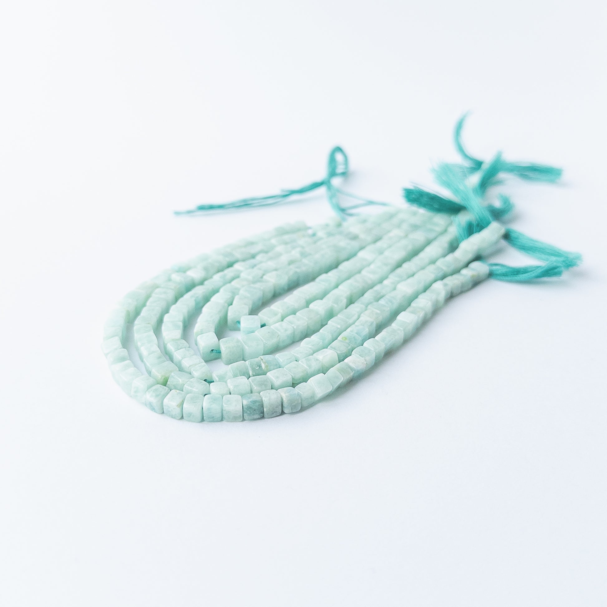Genuine Amazonite gemstone beads with smooth cube cut, perfect for artisan jewellery designs.