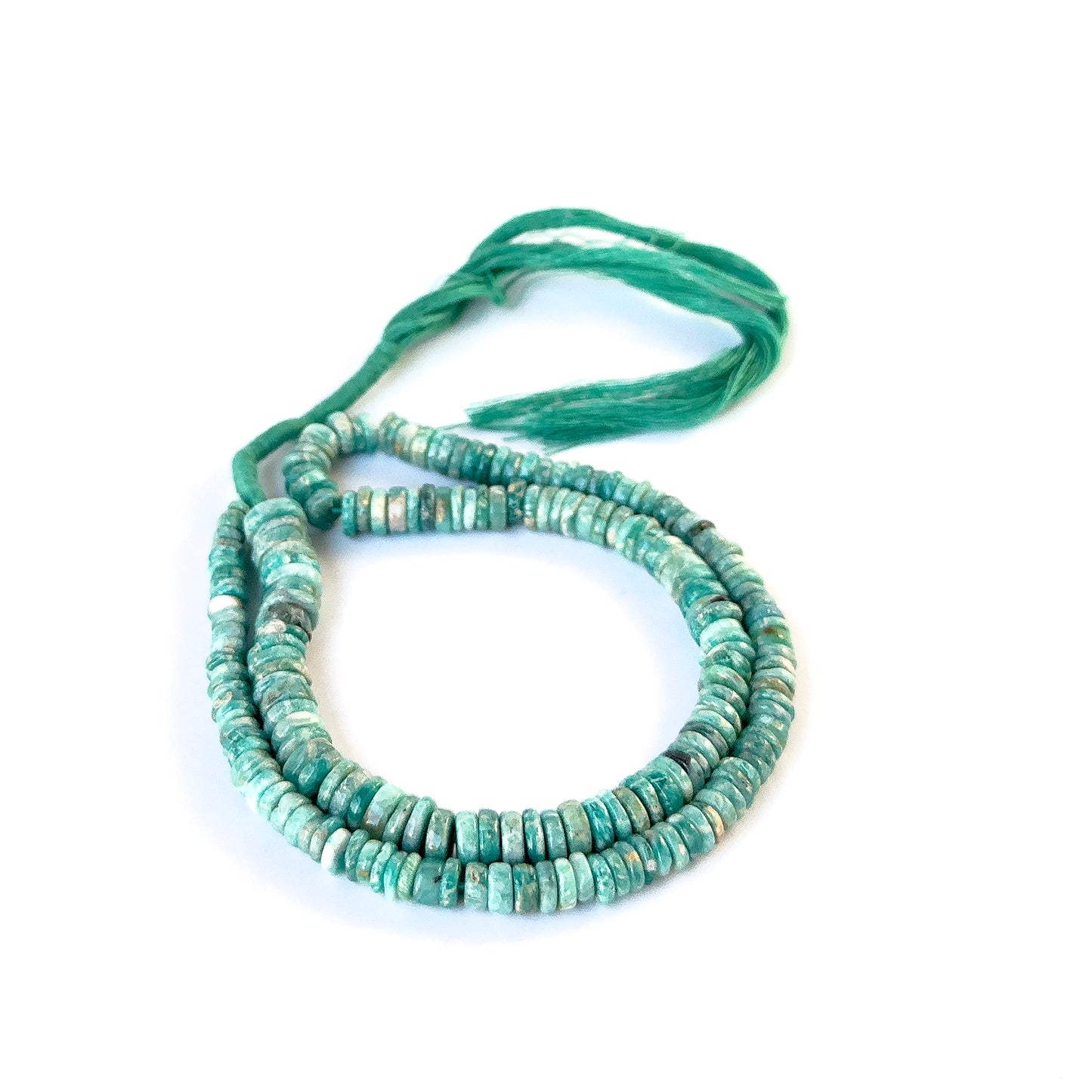 Authentic Amazonite gemstone beads arranged in a strand, highlighting their natural colour and refined finish.