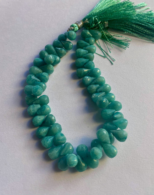 Amazonite faceted teardrop beads in soft aqua tones, arranged on a 21cm strand