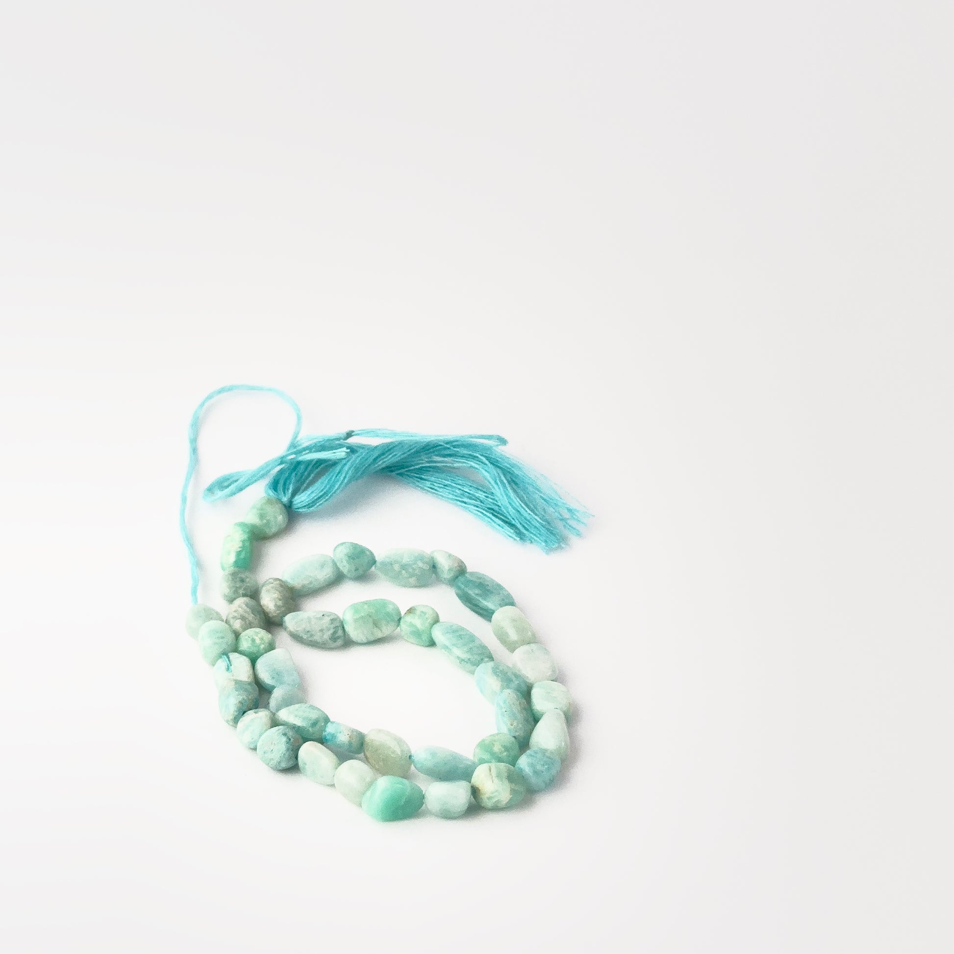 Genuine Amazonite tumble‑smooth beads, 5.5–6mm, arranged on a 33cm strand for handmade jewellery components.