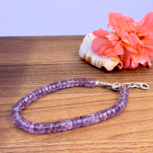 Amethyst bracelet with 5.9mm smooth wheel-cut natural gemstone beads and adjustable clasp.