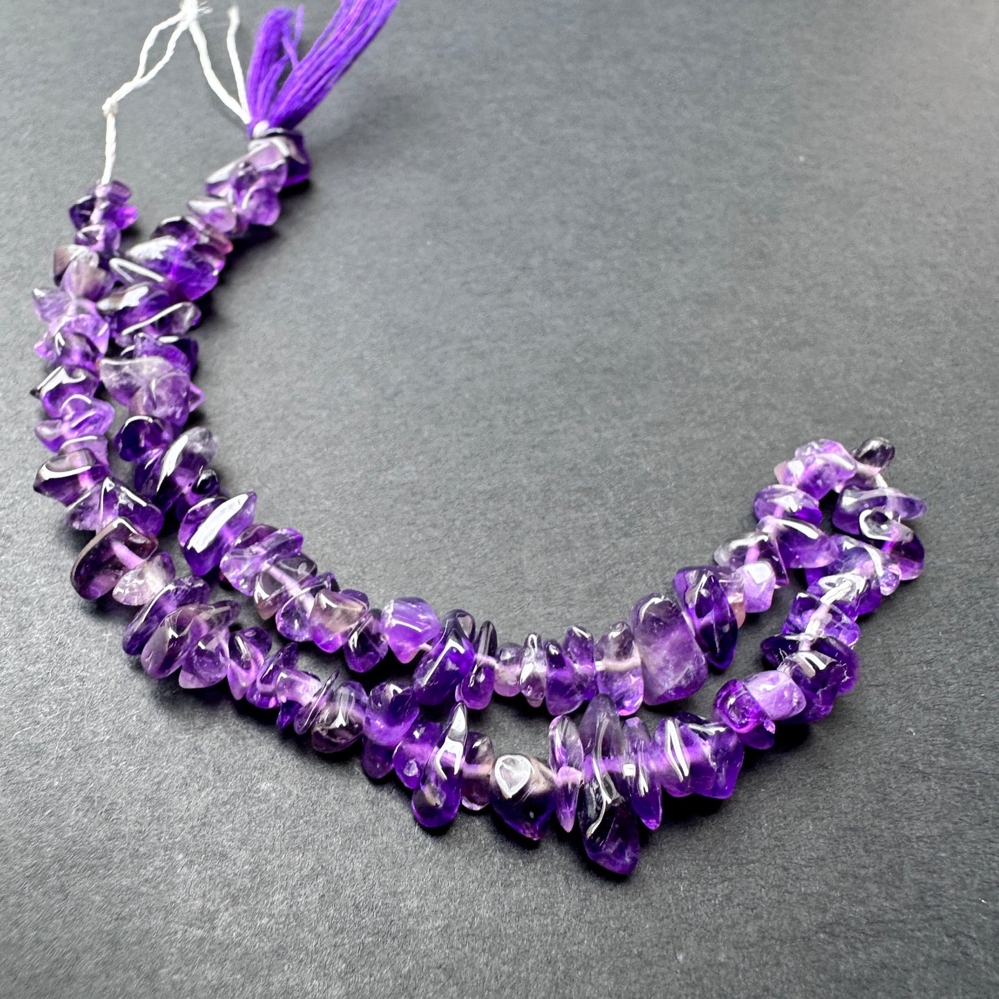 Handmade jewellery components featuring Amethyst beads with organic shapes and lustrous finish.