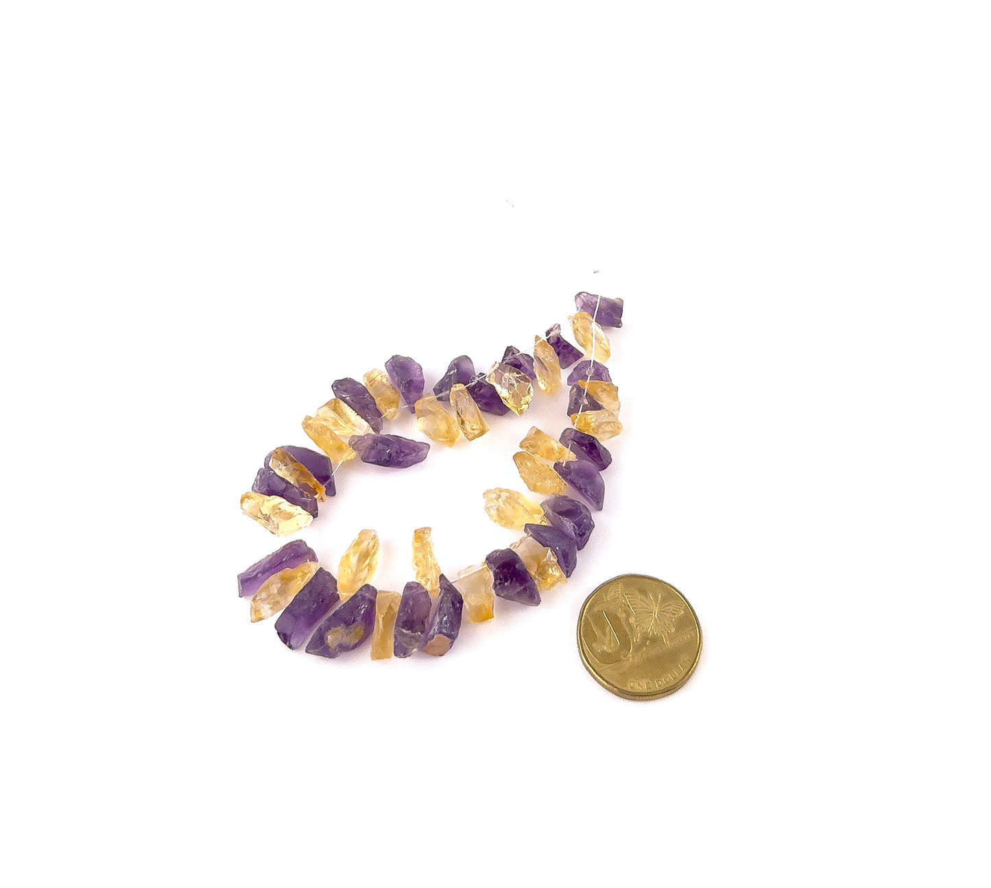 A coin is placed near Amethyst and Citrine drilled rough beads to show the 6–8mm size range.