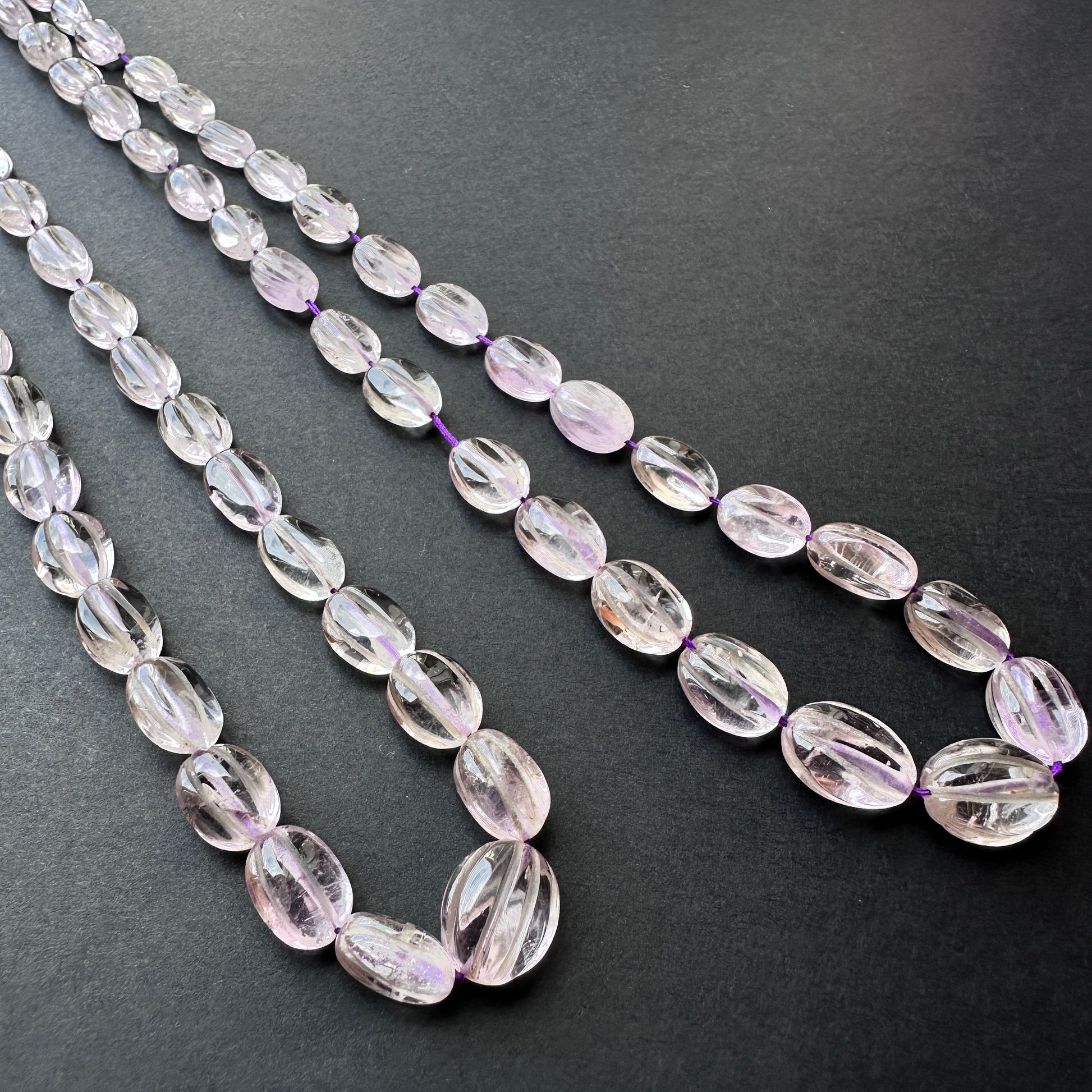 Stone beads arranged in a neat strand showcasing colour consistency and craftsmanship.