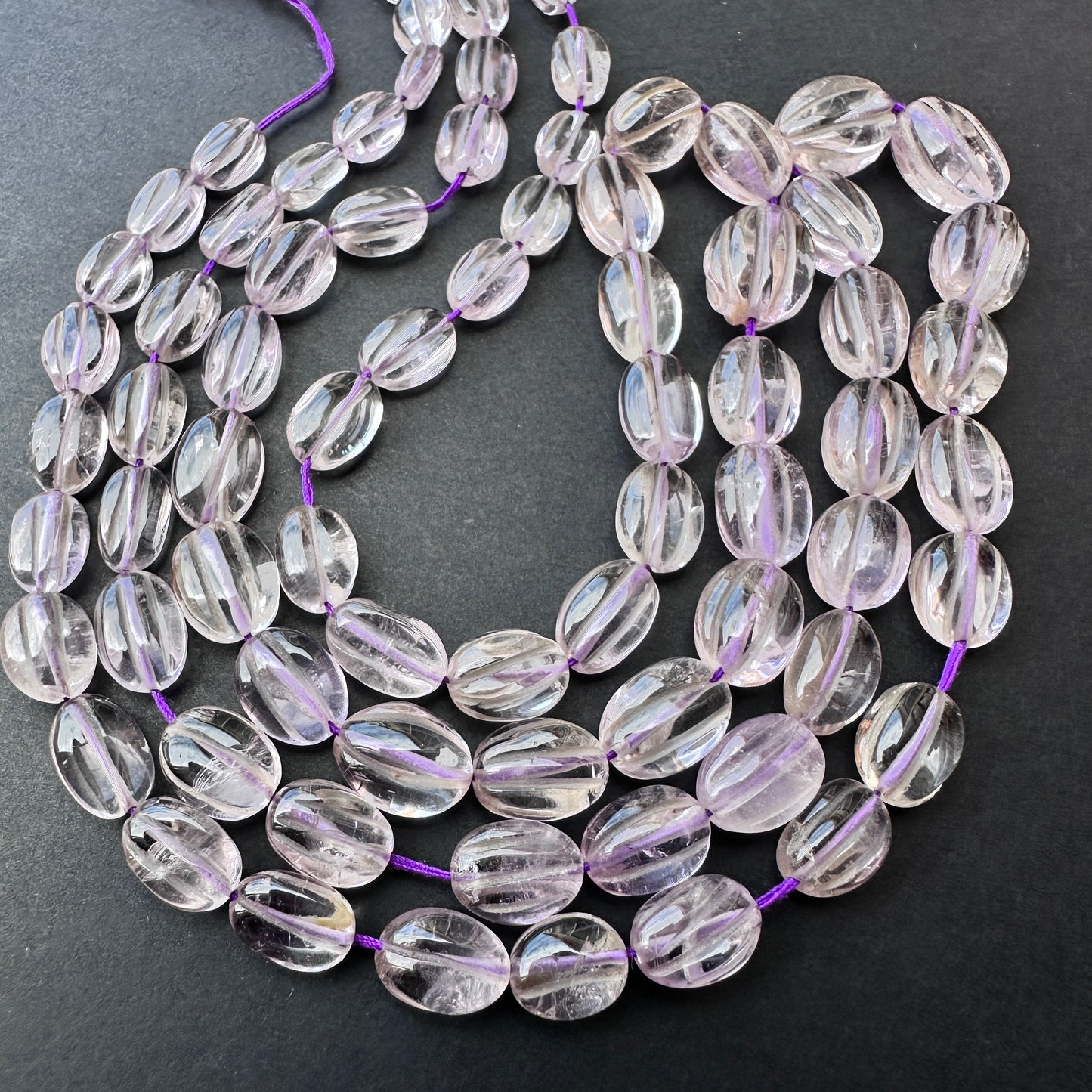 Natural amethyst gemstone beads in smooth oval cut, perfect for handmade jewellery and DIY designs. Strand length 40cm with 0.5mm bead holes.