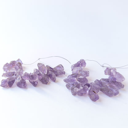 Raw Amethyst drilled rough beads in assorted 7.5–11mm sizes for artisan jewellery designs.